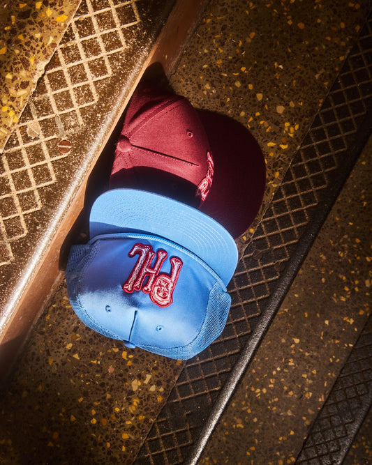 Philadelphia Phillies PHL snap back hats in Phillies maroon and Philadelphia Phillies light blue design. Maroon 5 panel snapback, light blue 5 panel surf style hat with corded brim